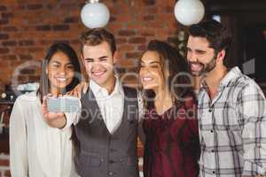 Smiling friends taking a selfie together