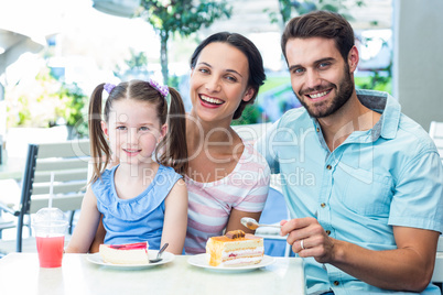 Portrait of a family eating at the restaurant
