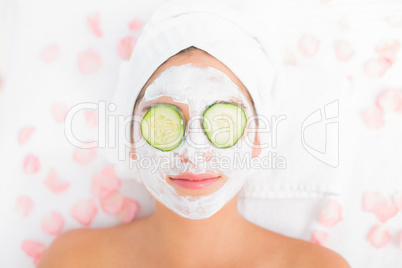 Attractive woman having cucumber on her face