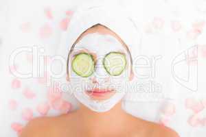 Attractive woman having cucumber on her face