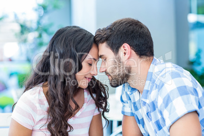 cute couple putting foreheads against each others
