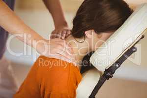 Young woman getting massage in chair