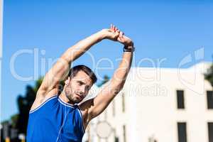 An handsome athlete stretching