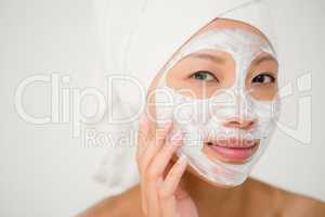 Attractive woman with cream treatment gesturing