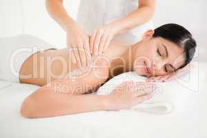 Woman enjoying a salt scrub massage
