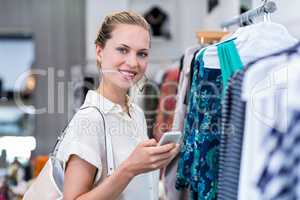 Smiling woman using smartphone