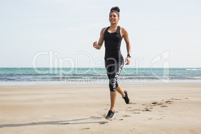 Fit woman jogging on the sand