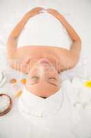 Relaxed woman lying on the massage table