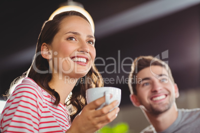 Smiling friends enjoying coffee together Smiling friends enjoying coffee together