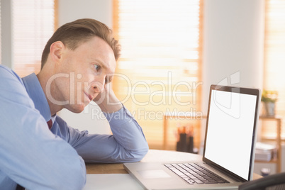 Focused businessman looking at laptop