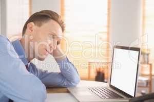 Focused businessman looking at laptop