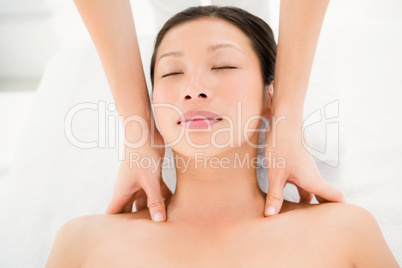 Attractive young woman receiving shoulder massage