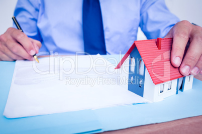 Businessman reading and writing a contrat before signing it