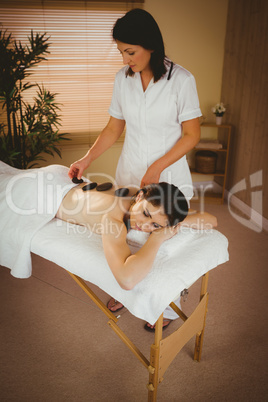 Young woman getting a hot stone massage