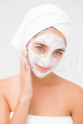 Attractive woman having white cream on her face