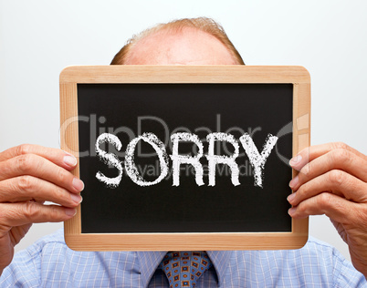 Sorry - Businessman with blackboard