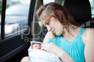 Mother with newborn in the car
