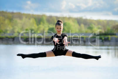 Young Gymnast is Up in the Air Doing Leg-Split