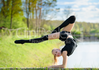 Rhythmic gymnast girl exercising with ribbon outdoor