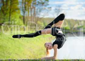 Rhythmic gymnast girl exercising with ribbon outdoor