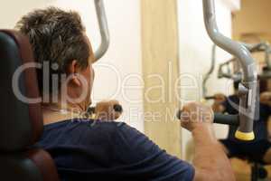 Man exercising on shoulder press machine