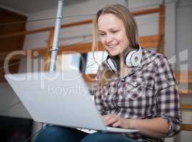 Woman spending leisure time with laptop at home