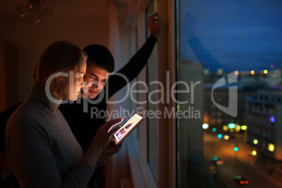 Couple with pad at home in the evening