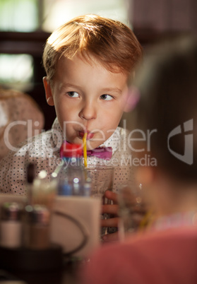 Little boy drinking with tubule