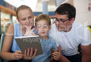 Parents and son with tablet PC at the airport