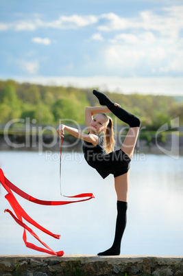 Rhythmic Gymnast in Vertical Split with Ribbon