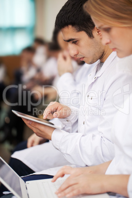 Medical students with modern devices on the lecture