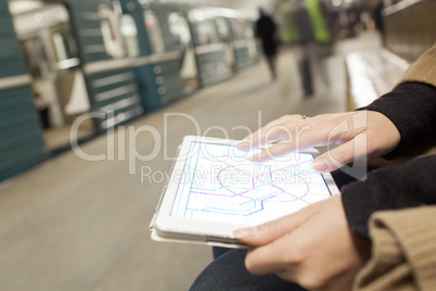 Woman with pad exploring underground map