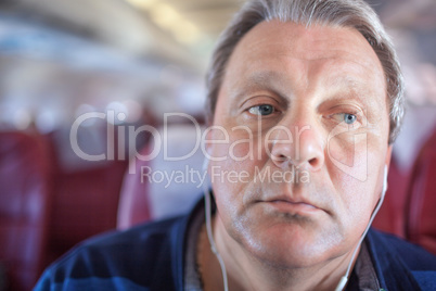 Man listening to music in the airplane