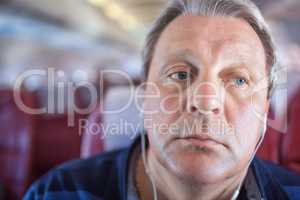 Man listening to music in the airplane