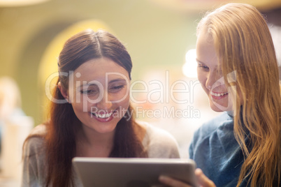 Happy young girls spending time with pad