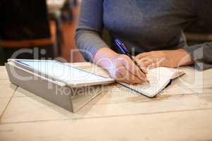 Woman taking down information in notebook