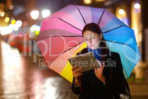 Woman with Tablet PC in the Rain