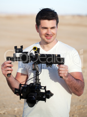 Smiling man with steadicam equipment outdoor