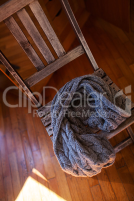Woollen scarf lying on wooden chair