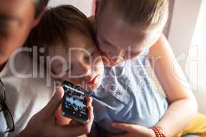 Child sleeping with music on cell phone in plane