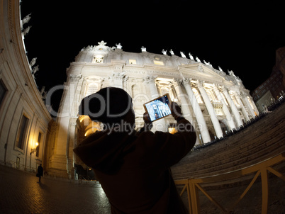 Tourist with pad shooting St. Peters Basilica in Vatican City