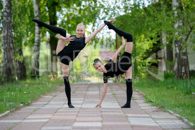 Young gymnast girls posing outdoor