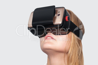 Young woman entertaining with VR-Helmet