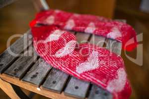 Red woollen socks on wooden chair