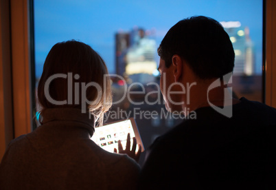 Couple Using Tablet PC in the Evening