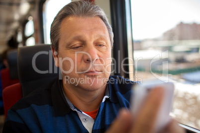 Man using mobile phone during train ride