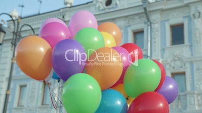 Hand holding multicolored balloons