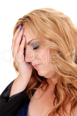 Blond woman holding her head.