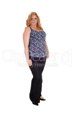 Plus size woman standing in jeans.