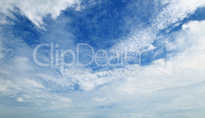 The white cumulus clouds against the blue sky